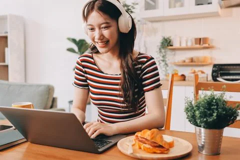 Asian woman using computer remote for business studying, watching online vi.. Fotos Stock