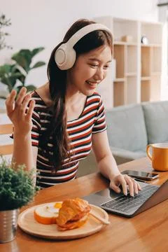 Asian woman using computer remote for business studying, watching online vi.. Fotos Stock