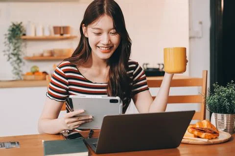 Asian woman using computer remote for business studying, watching online vi.. Fotos Stock