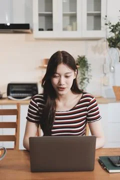 Asian woman using computer remote for business studying, watching online vi.. Фото