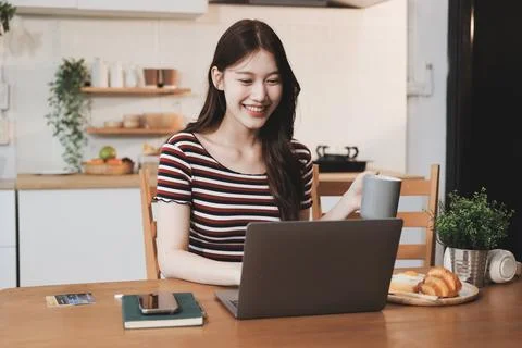 Asian woman using computer remote for business studying, watching online vi.. Фото
