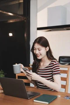 Asian woman using computer remote for business studying, watching online vi.. Фото