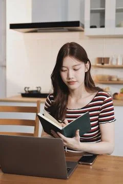 Asian woman using computer remote for business studying, watching online vi.. Фото