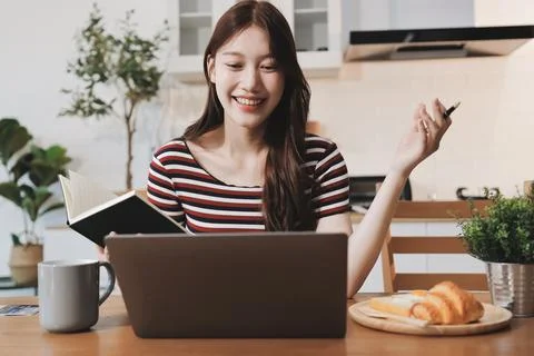 Asian woman using computer remote for business studying, watching online vi.. Фото