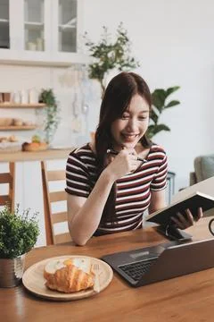 Asian woman using computer remote for business studying, watching online vi.. Фото