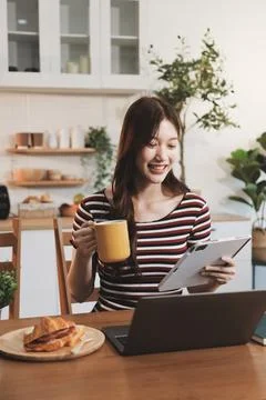 Asian woman using computer remote for business studying, watching online vi.. Фото