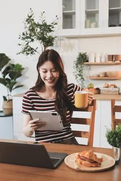 Asian woman using computer remote for business studying, watching online vi.. Фото