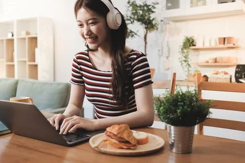 Asian woman using computer remote for business studying, watching online vi.. Фото