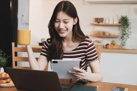 Asian woman using computer remote for business studying, watching online vi.. Фото