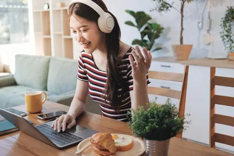 Asian woman using computer remote for business studying, watching online vi.. Фото
