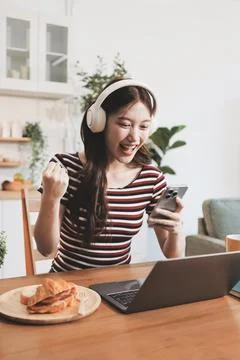Asian woman using computer remote for business studying, watching online vi.. Fotos Stock
