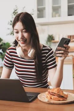 Asian woman using computer remote for business studying, watching online vi.. Фото