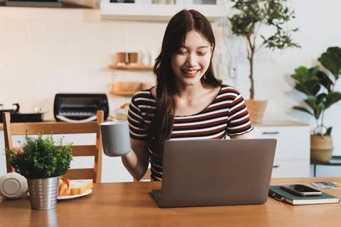 Asian woman using computer remote for business studying, watching online vi.. Фото