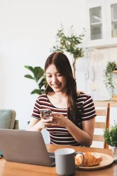Asian woman using computer remote for business studying, watching online vi.. Фото
