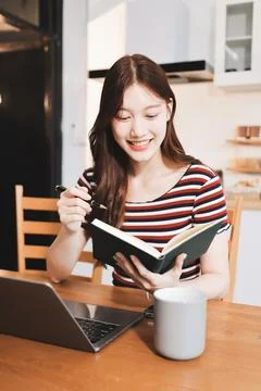Asian woman using computer remote for business studying, watching online vi.. Фото