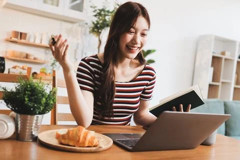 Asian woman using computer remote for business studying, watching online vi.. Фото