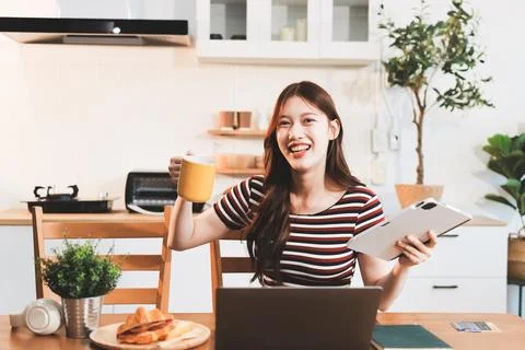 Asian woman using computer remote for business studying, watching online vi.. Фото