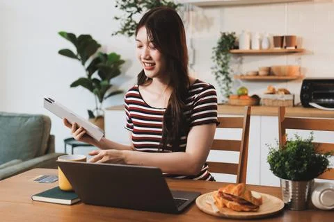 Asian woman using computer remote for business studying, watching online vi.. Фото