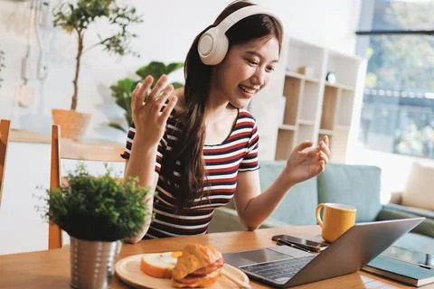 Asian woman using computer remote for business studying, watching online vi.. Фото