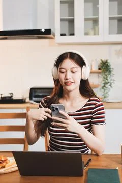 Asian woman using computer remote for business studying, watching online vi.. Фото