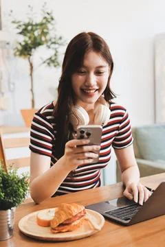 Asian woman using computer remote for business studying, watching online vi.. Фото