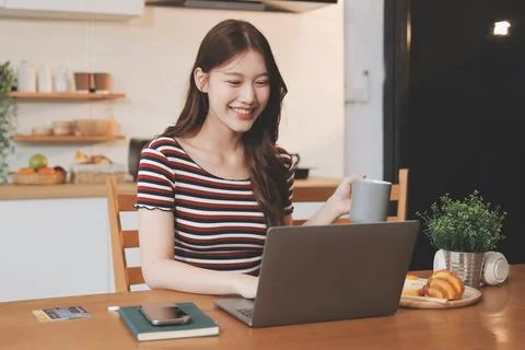 Asian woman using computer remote for business studying, watching online vi.. Stock Photos