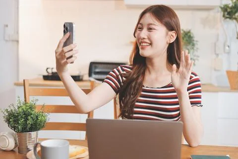 Asian woman using computer remote for business studying, watching online vi.. Stock Photos