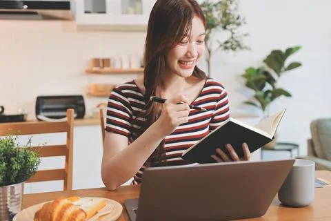 Asian woman using computer remote for business studying, watching online vi.. Stock Photos