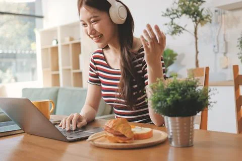 Asian woman using computer remote for business studying, watching online vi.. Stock Photos