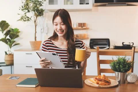 Asian woman using computer remote for business studying, watching online vi.. Stock Photos