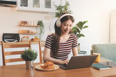 Asian woman using computer remote for business studying, watching online vi.. Stock Photos