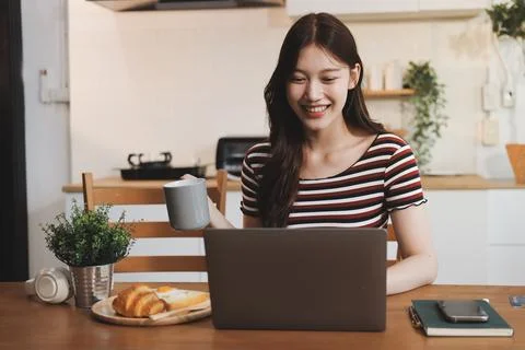 Asian woman using computer remote for business studying, watching online vi.. Stockfoto's