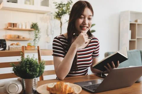 Asian woman using computer remote for business studying, watching online vi.. Stock Photos