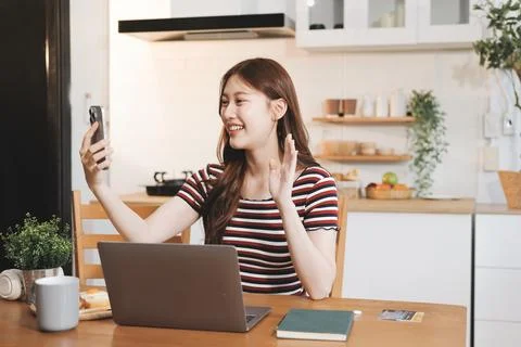Asian woman using computer remote for business studying, watching online vi.. Stockfoto's