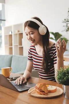 Asian woman using computer remote for business studying, watching online vi.. Stock Photos