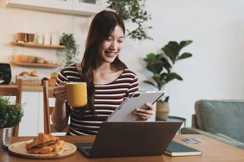 Asian woman using computer remote for business studying, watching online vi.. Stock Photos
