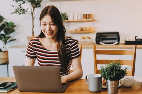 Asian woman using computer remote for business studying, watching online vi.. Stock Photos