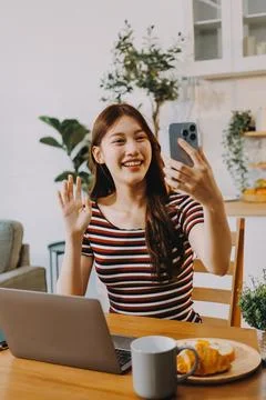 Asian woman using computer remote for business studying, watching online vi.. Stock Photos