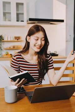 Asian woman using computer remote for business studying, watching online vi.. Stock Photos