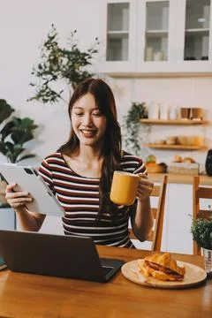 Asian woman using computer remote for business studying, watching online vi.. Stock Photos