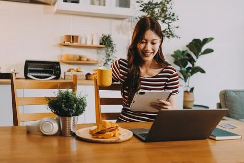 Asian woman using computer remote for business studying, watching online vi.. Stock Photos