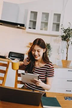 Asian woman using computer remote for business studying, watching online vi.. Stock Photos