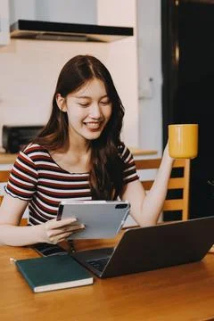 Asian woman using computer remote for business studying, watching online vi.. Stock Photos