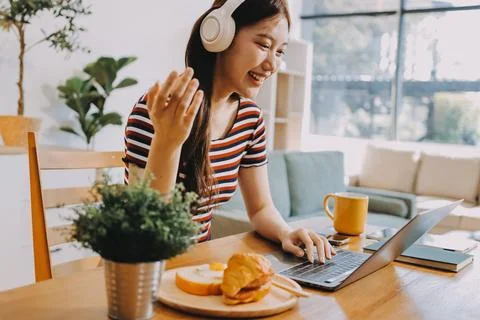 Asian woman using computer remote for business studying, watching online vi.. Stock Photos