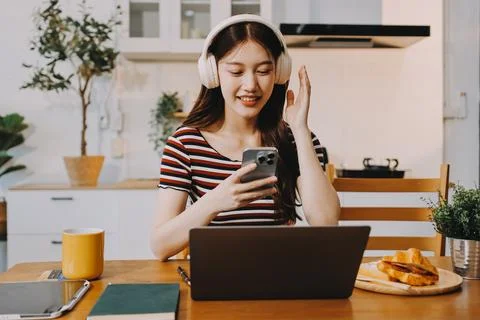 Asian woman using computer remote for business studying, watching online vi.. Stock Photos