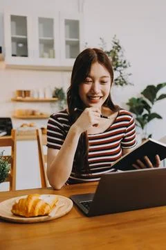 Asian woman using computer remote for business studying, watching online vi.. Stock Photos