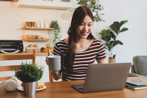 Asian woman using computer remote for business studying, watching online vi.. Stock-Fotos