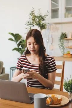Asian woman using computer remote for business studying, watching online vi.. Stock-Fotos