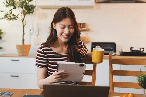 Asian woman using computer remote for business studying, watching online vi.. Stock-Fotos