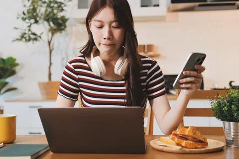 Asian woman using computer remote for business studying, watching online vi.. Stock-Fotos